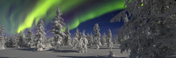 Northern Lights over snowy landscape in the high mountains in Fageråsen